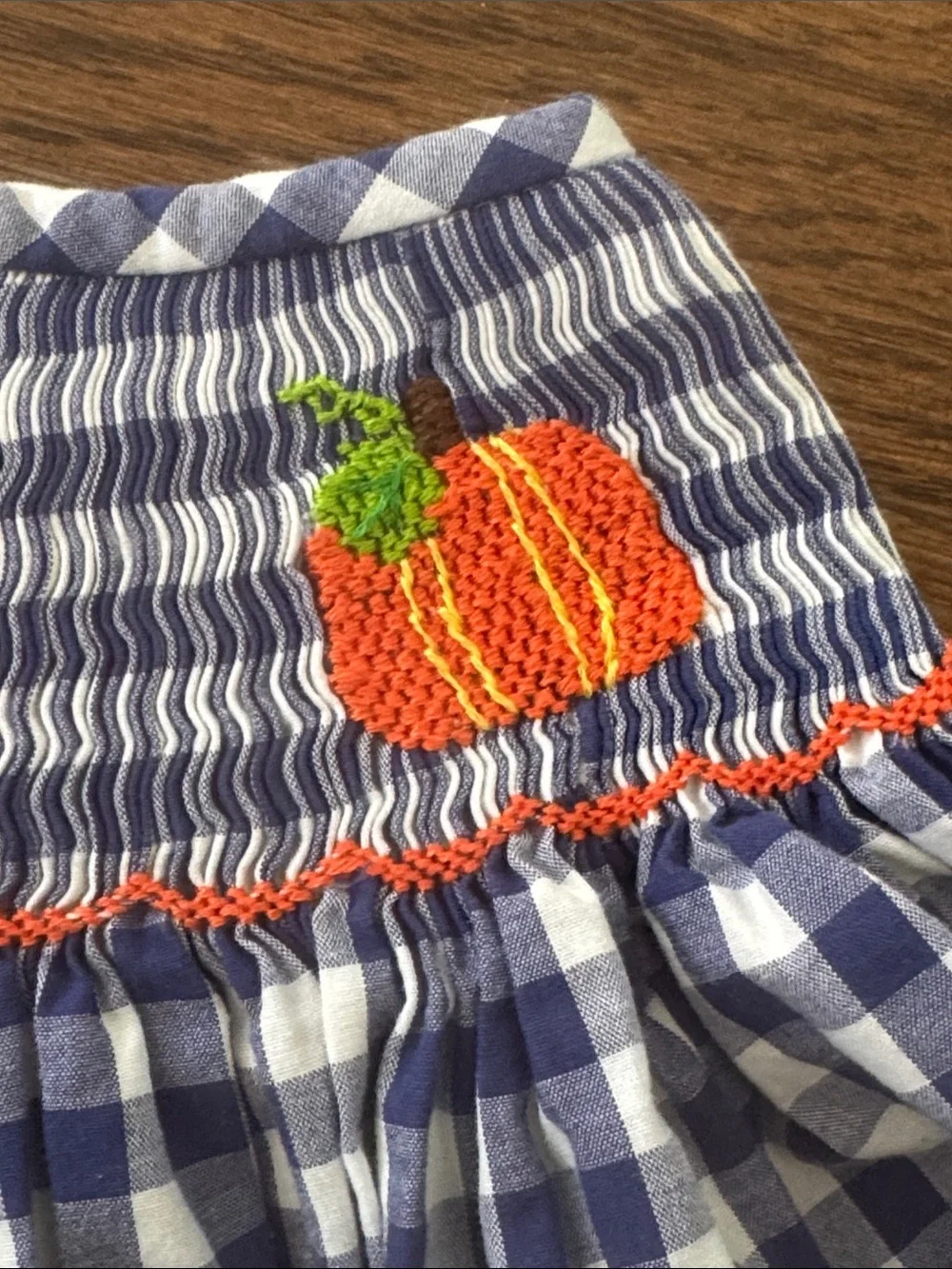 Cecil And Lou Navy Gingham Smocked Dress with Smocked Orange Pumpkin Embroidery